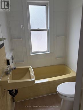 Toronto (Danforth) apartment for rent - A bathroom with a tub, toilet and sink.