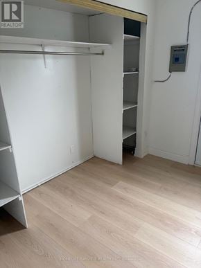 Toronto (Danforth) apartment for rent - A white closet with a wooden shelf and a door.