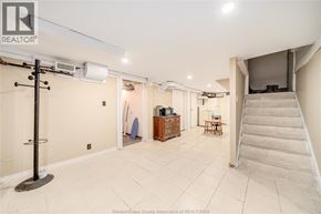 Windsor apartment for rent - A spacious room with a staircase leading to another level.