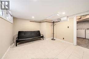 Windsor apartment for rent - A black sofa sits in a room with a white ceiling and a white washing machine in the background.