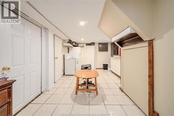 Windsor apartment for rent - A kitchen area with a table and a refrigerator.