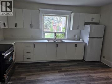 Cambridge apartment for rent - A kitchen with white cabinets and a window.