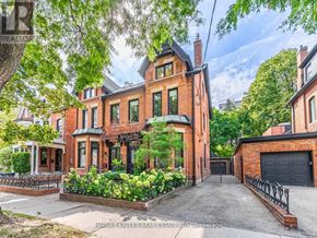 Toronto (Annex) apartment for rent - A large red brick house with a black gate in front.