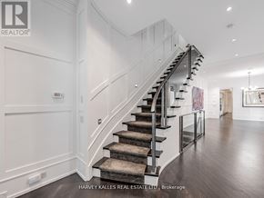 Toronto (Annex) apartment for rent - A staircase with a metal railing and a carpeted runner leads up to a landing with a door.