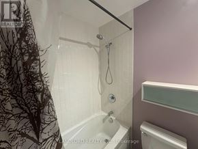 Toronto (Bay Street Corridor) condo for rent - A bathroom with a purple wall and a white tub.
