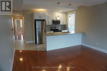 Ottawa apartment for rent - A kitchen with a refrigerator, microwave, and oven.