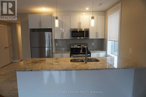 Ottawa apartment for rent - A kitchen with granite countertops and stainless steel appliances.