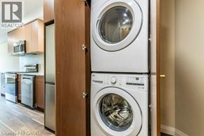 Waterloo condo for rent - A washing machine is placed next to a dryer in a laundry room.