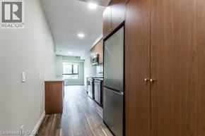 Waterloo condo for rent - A kitchen with wooden cabinets and a refrigerator.