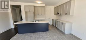 Adjala-Tosorontio (Colgan) apartment for rent - A kitchen with a large island and cabinets.