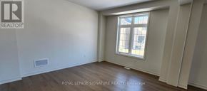 Adjala-Tosorontio (Colgan) apartment for rent - A room with a window and wooden flooring.