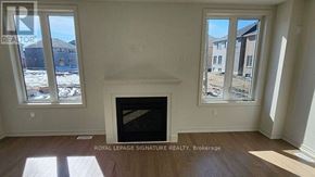 Adjala-Tosorontio (Colgan) apartment for rent - A room with a fireplace and two windows.