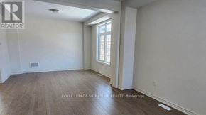 Adjala-Tosorontio (Colgan) apartment for rent - A room with a window and wooden flooring is on the market.