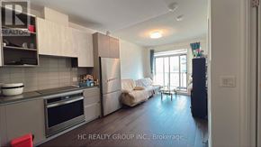 Richmond Hill (Doncrest) condo for rent - A kitchen with a refrigerator, oven, and sink.