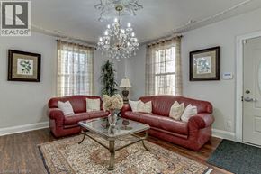 Scotland apartment for rent - A living room with red couches and a chandelier.
