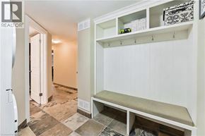 Burlington apartment for rent - A kitchen pantry with a white fridge and a bench.