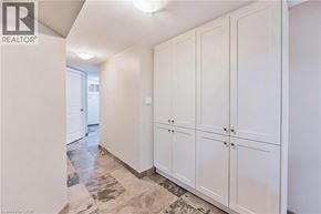 Burlington apartment for rent - A hallway with white cabinets and a tiled floor.
