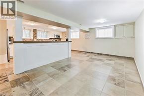 Burlington apartment for rent - A spacious kitchen with a tiled floor and a bar area.