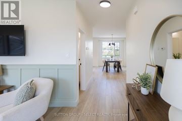 Thames Centre (Thorndale) townhouse for rent - A living room with a white couch and a television on the wall.