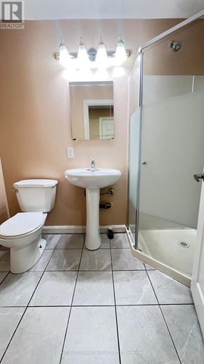 Toronto (Rouge) townhouse for rent - A bathroom with a toilet, sink, and shower.