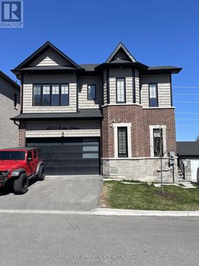 Oshawa (Mclaughlin) apartment for rent - A red truck is parked in front of a two-story house.