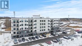 Thorold (Thorold Downtown) multi-family for rent - A large building with a parking lot in front of it.