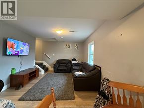 Windsor apartment for rent - A living room with a couch, chair, and television.