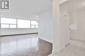 Toronto (Don Valley Village) condo for rent - A room with a white wall and a doorway leading to another room.