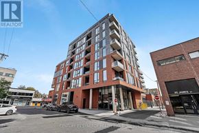 Ottawa condo for rent - A modern red brick building with a glass entrance and a sign that reads "20 JANE'S".