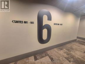 Ottawa condo for rent - A wall with a large number 6 and a sign for "suites 601-603" in a building.