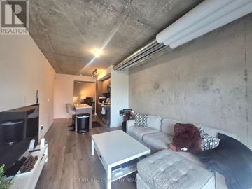 Ottawa condo for rent - A living room with a grey couch and a white coffee table.