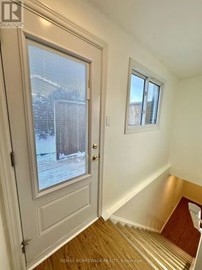 Ottawa apartment for rent - A white door with a window and a small window above it.