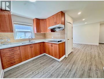 Toronto (Tam O'shanter-Sullivan) apartment for rent - A kitchen with wooden cabinets and a white countertop.