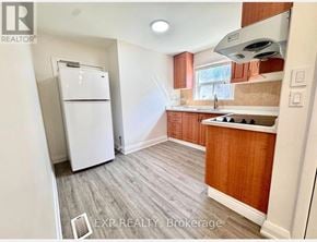 Toronto (Tam O'shanter-Sullivan) apartment for rent - A kitchen with a white fridge and wooden cabinets.
