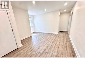Toronto (Tam O'shanter-Sullivan) apartment for rent - A room with wooden flooring and white walls, with a door on the left and a window on the right.