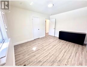 Toronto (Tam O'shanter-Sullivan) apartment for rent - A room with wooden flooring and white walls, with a window on the left side.