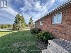 Clarington apartment for rent - A house with a brown roof and a green lawn in front.