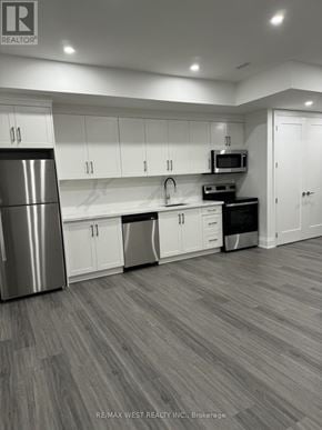 Toronto (Humber Summit) apartment for rent - A modern kitchen with white cabinets and a stainless steel refrigerator.