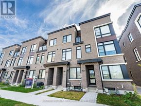 Toronto (Bendale) townhouse for rent - A modern brick apartment building with a clear sky in the background.