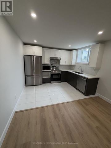 London South (South U) apartment for rent - A kitchen with a refrigerator, oven, and sink.