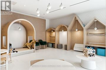 Toronto (Dovercourt-Wallace Emerson-Junction) condo for rent - A modern living room with a white table and a giraffe plush toy.