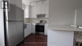 Toronto (East End-Danforth) apartment for rent - A kitchen with white cabinets and a stainless steel refrigerator.