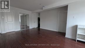 Toronto (East End-Danforth) apartment for rent - A room with wood flooring and white walls, with a white cabinet on the right.