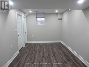 Brampton (Toronto Gore Rural Estate) apartment for rent - A room with wooden flooring and white walls.