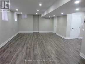 Brampton (Toronto Gore Rural Estate) apartment for rent - A spacious room with wood flooring and white walls.