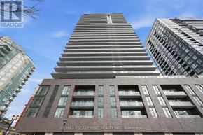 Burlington (Brant) condo for rent - A tall building with a sign that reads "R/MAX ESCARPMENT REALTY INC. Brokerage" in front of it.