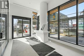 Burlington (Brant) condo for rent - A modern interior space with a view of a construction site outside the windows.