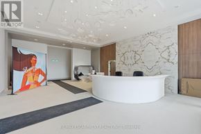 Burlington (Brant) condo for rent - A reception area with a white reception desk and a large poster on the wall.