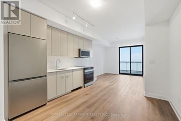 Burlington (Brant) condo for rent - A kitchen with a refrigerator, microwave, and oven.