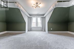 Hamilton (Kirkendall) apartment for rent - A spacious room with a large window and a chandelier.